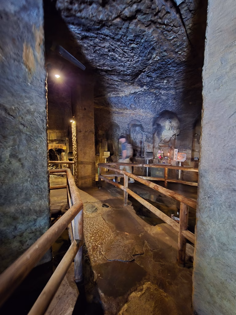 Narrow stone passage inside the Benten-kutsu Caves at Hasedera Temple in Kamakura