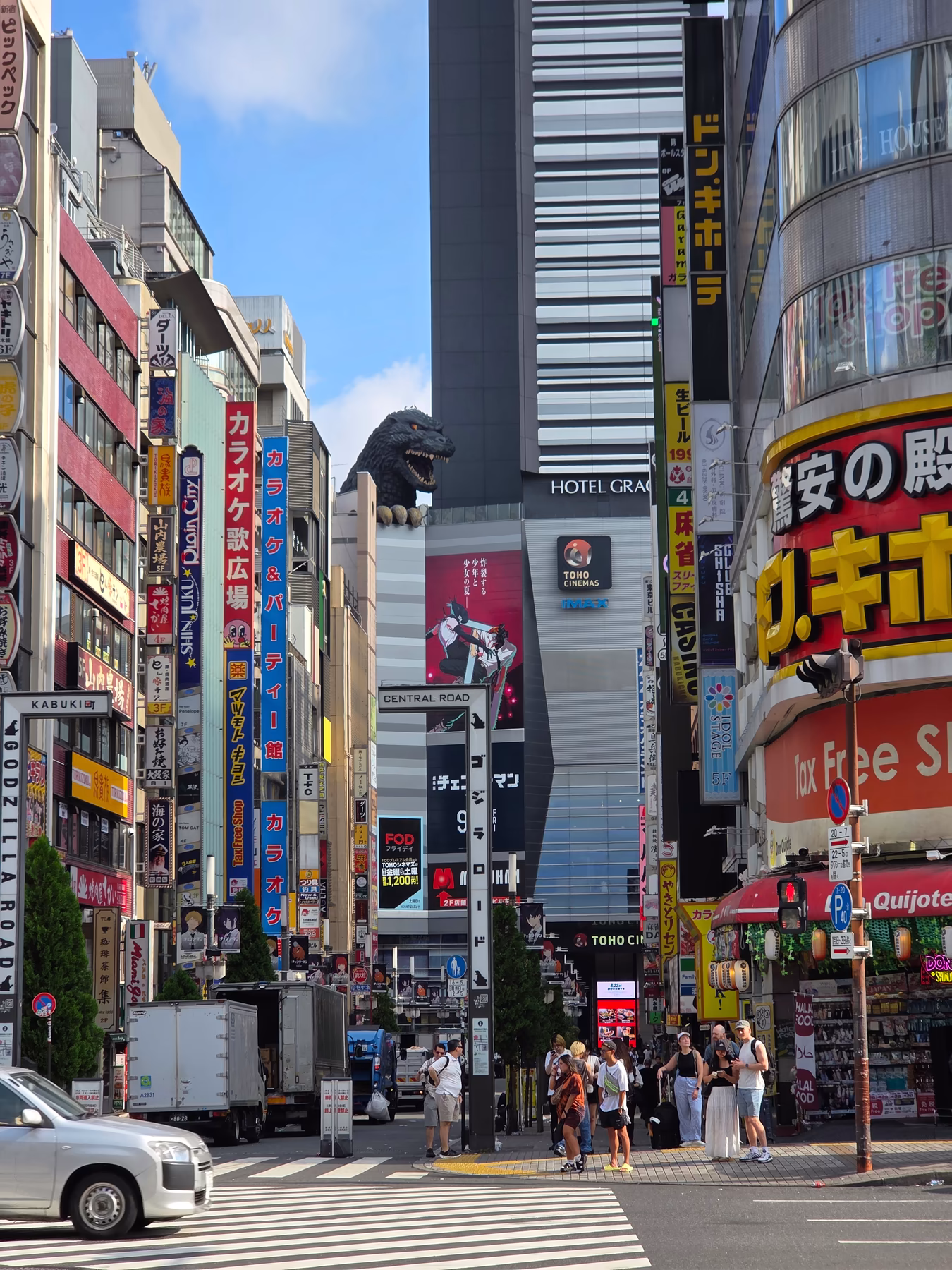 Godzilla head overlooking Shinjuku streets on a clear day in Tokyo