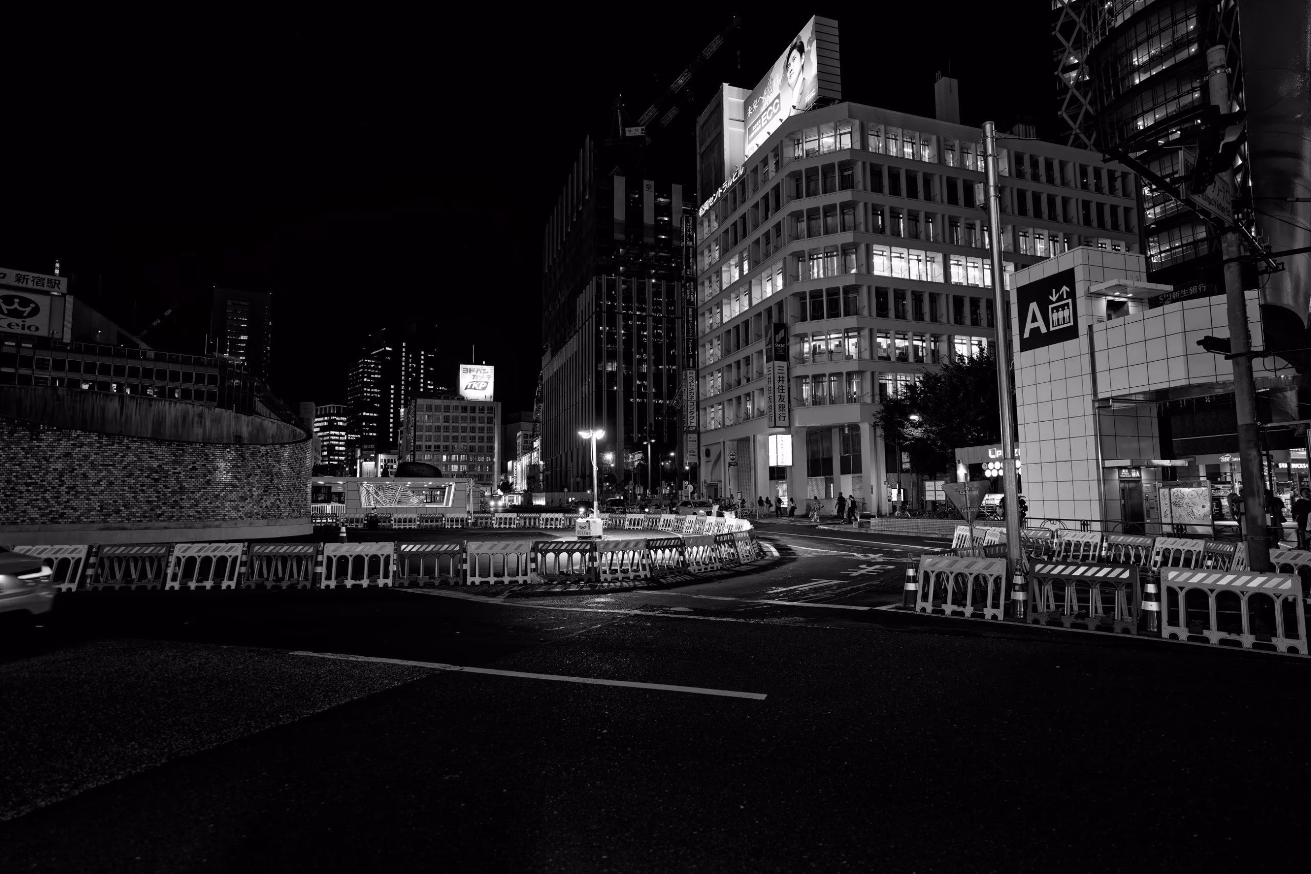 Shinjuku street glowing with neon signs at night