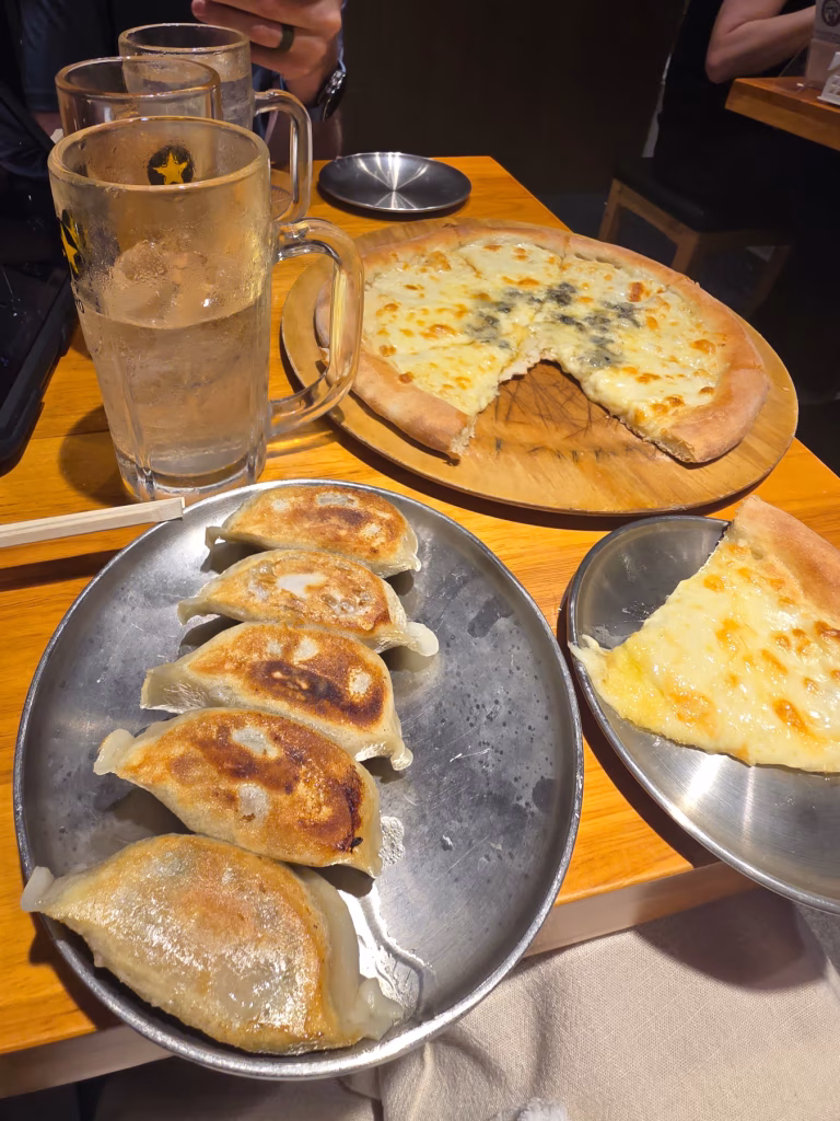 Japanese izakaya dinner with gyoza, pizza and whiskey highballs.