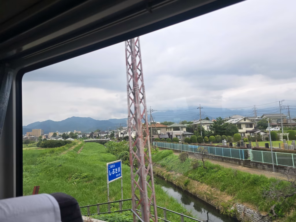 View from Romancecar train window of countryside between Tokyo and Hakone