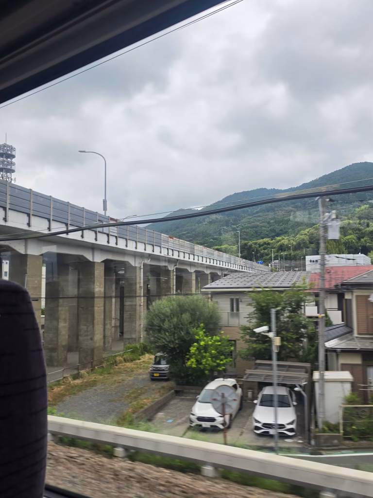 View from Romancecar train window of countryside between Tokyo and Hakone