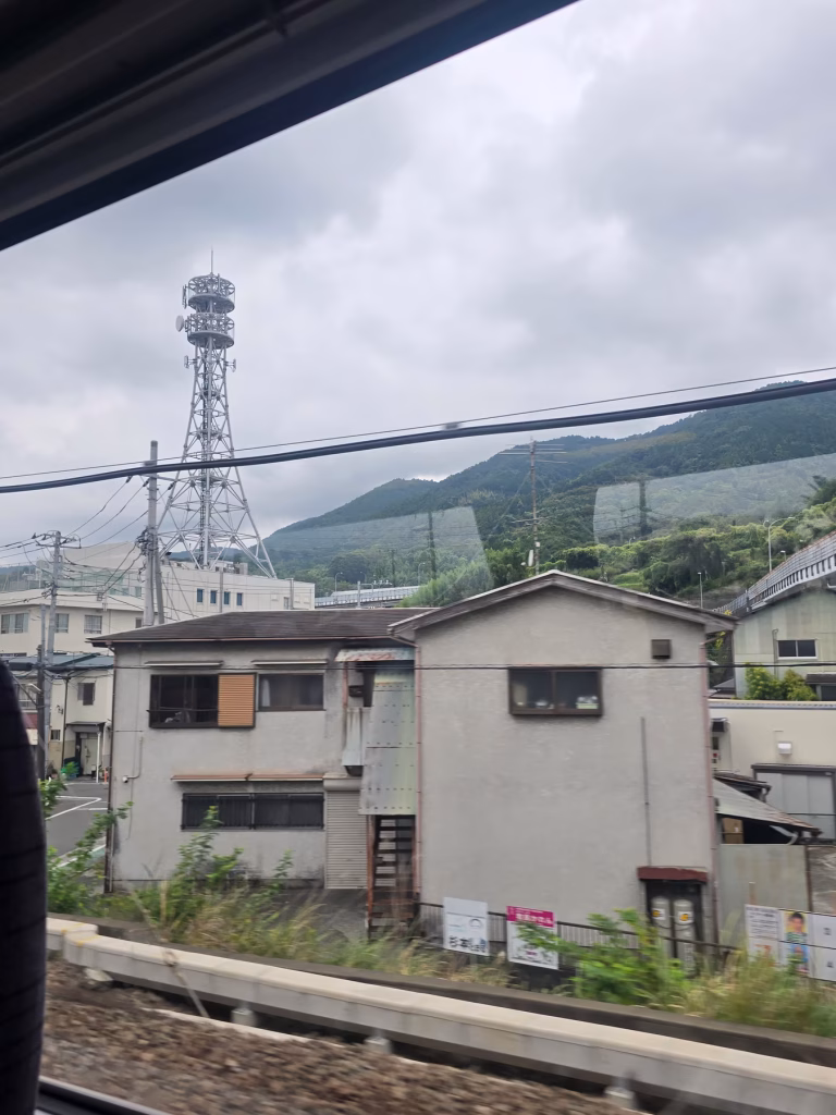 View from Romancecar train window of countryside between Tokyo and Hakone