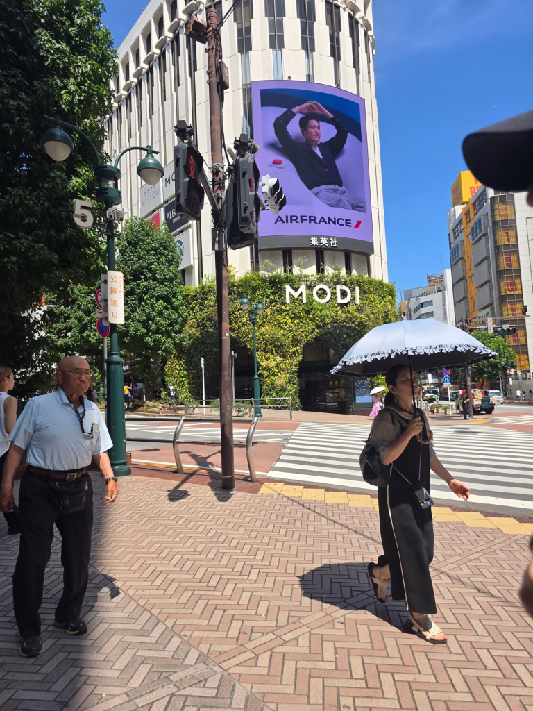 Pedestrians walking past the Shibuya MODI shopping Mall in Shibuya area of Tokyo in early morning.